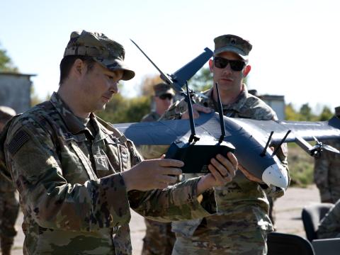 Chief Warrant Officer 2 Christian R. Lehr (l) and Sgt. 1st Class Andrew J. Baumgardner (r), members of the 2nd Multi-Domain Effects Battalion Innovation Center, perform pre-flight checks prior to testing the MDEB’s newest experimental unmanned aerial vehicle in May, in Ustka, Poland. Arcane Thunder 25 promotes innovation, collaboration and interoperability between allied and partner nations. Credit: Sgt. 1st Class John Healy