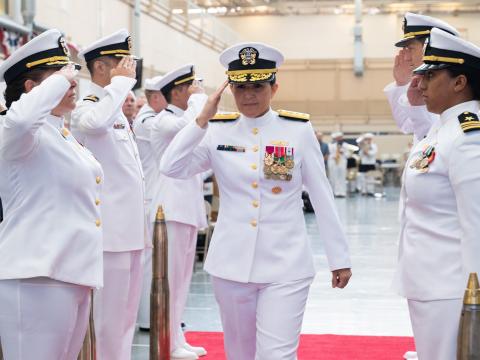 Now-Vice Adm. Seiko Okano, principal military deputy, assistant secretary of the Navy for research, development and acquisition, salutes the sideboys during the Tactical Networks Program Office (PMW 160) change of command ceremony August 29, 2024. Credit: U.S. Navy photo by Ramon Go