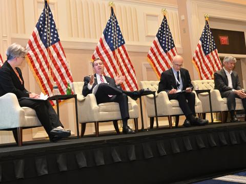 Scott Bumgarner, intelligence community senior procurement executive at the Office of the Director of National Intelligence (second from l), speaks at the 2025 Intelligence & National Security Summit held in National Harbor, Maryland. Credit: Herman Farrer Photography