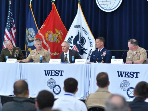 Rear Adm. Joseph Buzzella (second from the right) explains the adversarial challenges facing the U.S. Coast Guard on February 12, 2026, at WEST in San Diego. Credit: Karras Photography