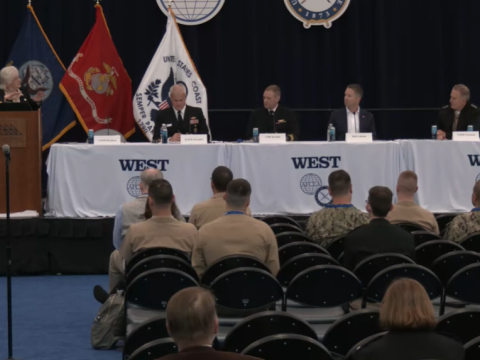 Navy panel shares the stage during a WEST 2026 discussion.