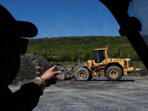 U.S. Air Force Master Sgt. Phillip Rubalcava, a superintendent at the 316th Civil Engineer Squadron, oversees front-end loader training during a bivouac exercise held by the wing at Fort Indiantown Gap, Pennsylvania on April 27, 2026. The Cybersecurity and Infrastructure Security Agency is beginning a new program called Critical Infrastructure Fortify, or CI Fortify,  which will conduct assessments of military land other critical infrastructure. Credit: Airman 1st Class Patrick Nigugana