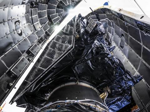 A Lockheed Martin GPS III satellite is encapsulated into the fairings of a SpaceX Falcon 9 Rocket in preparation for the National Security Space Launch GPS III-8 mission, Cape Canaveral Space Force Station, Florida, April 15, 2026. Credit: Maj. Brittany Curry