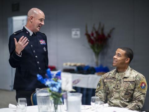 Space Force Col. Andrew Menschner, deputy commander of Space Systems Command, and Air Force 1st Lt. Dorian Maynard, officer in charge of the 61st contracting flight, Space Base Delta 3, speak during a STEM scholarship luncheon at Los Angeles Air Force Base in El Segundo, California, on Sept. 22, 2026. Credit: Van Ha