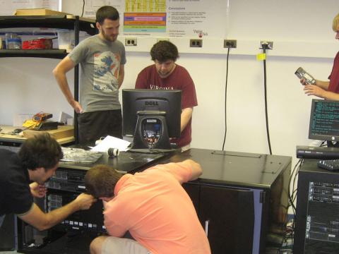 Students in a Virginia Tech laboratory test Popcorn Linux, an operating system that can compile different programming languages into a single cyber tongue. The research is a collaborative effort between the university and the Office of Naval Research. Photo courtesy Binoy Ravindran