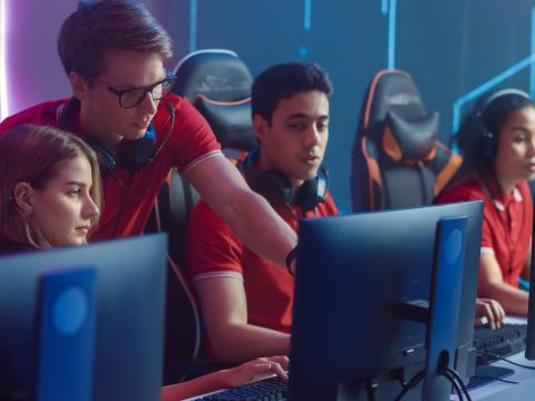 A group of gamers compete in a championship tournament. One method of drawing young people into the cybersecurity field would employ gamification to providequantifiable ways of training in an interactive realm. Gorodenkoff/Shutterstock
