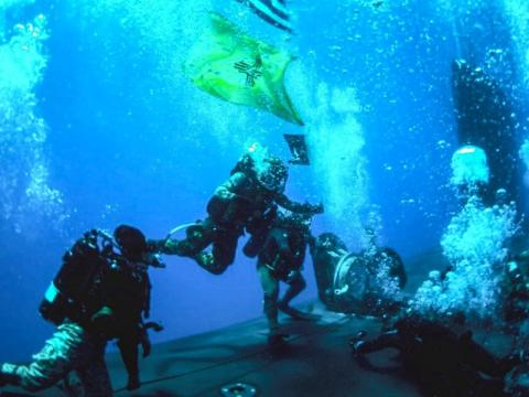 Navy SEALs conduct diving operations with the attack submarine USS New Mexico during training in the Mediterranean Sea in June 2021. The Undersea Warfighting Development Center helps integrate a variety of technologies and capabilities for the undersea warfare mission. Photo courtesy of U.S. Navy