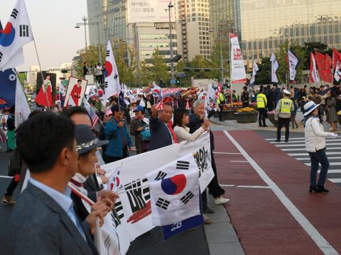 Influence operations in the invisible world of cyberspace have real-world consequences. After South Koreans heard about the disinformation campaign that helped elect Park Geun-hye as the republic’s president, they took to the streets to protest against the government. Credit: Steve Edreff/Shutterstock.com