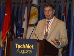 Col. Mike Warlick, USMC (Ret.) thanks U.S. Army officials during AFCEA's 10th Annual TechNet Augusta event for the honor of being recognized as a Brevet Colonel, a high military honor. Credit: Michael Carpenter 