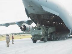 A Hight Mobility Artillery Rocket System vehicle and directs the driver off the tarmac on Andersen Air Force Base, Guam. Photo By: Maj. Jonathon Daniell, U.S. Army.