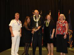 Rear Adm. Richard Macke, USN (Ret.), center, is honored in April 2022 with the Chair’s Superior Performance Award. Adm. Samuel Paparo, USN, Commander, U.S. Pacific Fleet, far left, presented the award. On Macke's left is his wife, Susie Macke. On his right is Lt. Gen. Susan S. Lawrence, USA (Ret.), AFCEA's president and CEO, and Linda Newton, president of the AFCEA Hawaii Chapter.