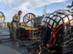 Sailors prepare material recovered from a Chinese high-altitude surveillance balloon for transport to federal agents at Joint Expeditionary Base Little Creek, Virginia, during operations in the Atlantic Ocean. Photo by U.S. Navy Petty Officer 1st Class Ryan Seelbach