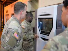 Brig. Gen. Joshua Rudd, deputy commanding general, Operations, 25th Infantry Division, observes Sgt. Terel Lewis, an allied trade specialist from the Army's 536th Support Maintenance Company, operates a 3D printing machine in operation in June 2020 at Schofield Barracks, HI. Credit: Army photo by Staff Sgt. Richard Lower