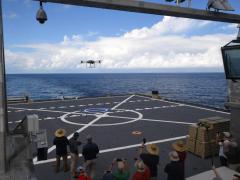 Crewmembers from the engineering company Survice, aboard the Spearhead-Class expeditionary fast transport vessel USNS Burlington (T-EPF-10) land the Tactical Resupply Vehicle (TRV) 150 unmanned aerial system practice landing on the ship autonomously amongst onlookers from the Scientists-to-Sea program underway during the Navy’s Fleet Experimentation Program, Oct. 17, 2022. The event was organized by the Office of Naval Research-sponsored SCOUT initiative and U.S. Fourth Fleet, held in Key West, Florida.