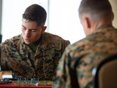 A U.S. Marine plays a war-themed strategy board game based on World War II battles in Camp Schwab, Okinawa, Japan in 2019. Credit: Cpl. Timothy Hernandez, U.S. Marine Corps.