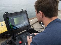 An equipment operator uses an underwater drone to inspect a Latvian pier in Liepaja, Latvia. Credit: Mass Communication Specialist 2nd Class Andrew Waters, U.S. Navy.