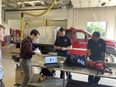 TDA staff members provide an overview of the wearable chemical sensor badges and show Fairmount firefighters and responders how they work. Credit: TDA Research