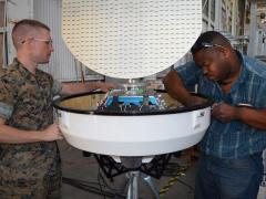 Military and civilian technical experts from Program Executive Office, Command, Control, Communications, Computers and Intelligence inspect a portable Doppler weather radar. Credit: Dawn Stankus, U.S. Navy