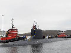 USS Virginia sailors stand topside as their friends and families cheer their arrival in 2018. Photo credit U.S. Navy.