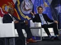 Acting Principal Deputy National Cyber Director Jake Braun (r) speaks with Col. Michael Black, USAF (Ret.), vice president of defense at AFCEA International (l), on June 26 during AFCEA's annual TechNet Cyber conference in Baltimore. 