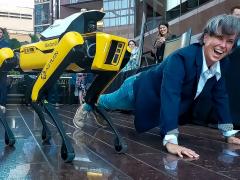 Col. Brandi B. Peasley competes in a pushup challenge against a DroneDog during a dual-use technology event. Credit: Staff Sgt. John Carkeet IV, U.S. Army