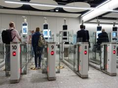 Facial recognition technologies continue to advance for travel security. In the United Kingdom, travelers pass through automated border control in November 2019. Credit: 1000 Words/Shutterstock