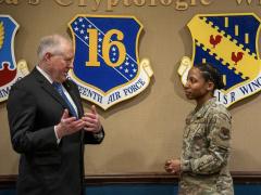 Secretary of the Air Force Frank Kendall speaks with U.S. Air Force Tech. Sgt. Shannon Meads, 70th Operations Support Squadron publicly available information operations noncommissioned officer in charge, during a visit at Fort Meade, Maryland, on February 2, 2024. The 16th Air Force is targeting “deliberate partnerships” to aid its information warfare efforts. Credit: U.S. Air Force photo by Tech. Sgt. Kevin Iinuma.