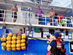The USCGC Frederick Hatch conducts fisheries boardings in the Palau exclusive economic zone and addresses a Philippine crew using translations on a tablet. Credit: U.S Coast Guard