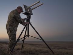 U.S. Space Force Tech Sgt. Kyle Yeager prepares an electronic warfare helical antenna in an exercise.