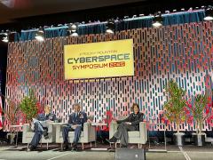 Brig. Gen. Matthew Cantore, USSF (l-r) and Brig. Gen. Stephen Slade speak with Maj. Gen. Kim Crider (Ret.) at the Rocky Mountain Cyber Symposium in Colorado Springs, Colorado.