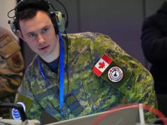 Royal Canadian Air Force Maj. Cody-Jean Carignan leads the multinational Tactical Operations Center-Light cell during the ShOC-N Capstone 24B experiment event at Nellis Air Force Base in December 2024. The 805th Combat Training Squadron executed the second of two capstone events developing tactics for integrated two-way kill chain automation between the operational and tactical command and control to create competitive advantages for the United States and its allies. U.S. Air Force photo by Deb Henley