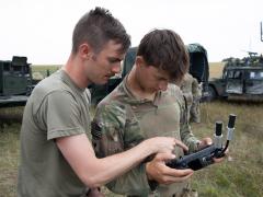 U.S. Army Staff Sgt. Jonathon Melvin (l) instructs U.S. Army Spc. Max Boatner on drone flight operations at Norio Training Area, Georgia, in August, during Agile Spirit 25. Both soldiers are assigned to Hawkeye Platoon, Headquarters and Headquarters Troop, 1st Squadron, 91st Cavalry Regiment, 173rd Airborne Brigade. The team leveraged small unmanned aircraft systems to demonstrate aerial resupply and mission-specific payload deployment using custom 3D-printed attachments.  U.S. Army National Guard photo