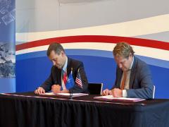 GA-ASI CEO Linden Blue (left) and Dutch Minister for Arms Procurement and Personnel Gijs Tuinman (right) sign an agreement. Credit: GA-ASI