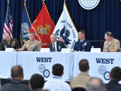 Rear Adm. Joseph Buzzella (second from the right) explains the adversarial challenges facing the U.S. Coast Guard on February 12, 2026, at WEST in San Diego. Credit: Karras Photography