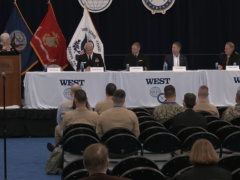 Navy panel shares the stage during a WEST 2026 discussion.