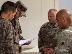 U.S. Army Maj. Jay Jackson, African Lion 2026 (AL26) Tunisia lead planner (G7) for U.S. Army Southern European Task Force, Africa (SETAF-AF) (r), reviews the minutes (a planning agreement) with Lt. Col. Corbett Baxter, African Lion lead planner (G7), SETAF-AF, and Tunisian Armed Forces Senior Col. Mguidich Mejid, exercise director for AL26, at the initial planning event for the exercise at El Aouina Air Base, Tunis, Tunisia, September 2025. U.S. Army photo by Maj. Joe Legros