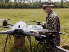 U.S. Marine Corps Lance Cpl. Quinn Stillman, a small unmanned aerial system operator with Combat Logistics Regiment 2, 2nd Marine Logistics Group, changes the battery on a TRV150 unmanned aerial system during a tactical demonstration. With the Lift Challenge, the Defense Advanced Research Projects Agency intends to dramatically increase small drone payload capabilities. Lance Cpl. Hunter Kuester/U.S. Marine Corps