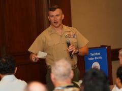 Col. Michael Hlad, USMC, commander of DISA’s Regional Field Command Pacific, speaks at TechNet Indo-Pacific 2026. Credit: Artistic Mindz Photography