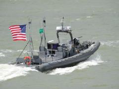 An unmanned boat from Naval Surface Warfare Center Carderock operates autonomously during a demonstration of swarmboat technology being developed by the Office of Naval Research.