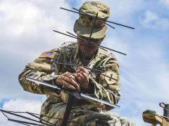 A soldier helps set up a tactical command post to test communications in Germany, July 8, 2019.  Photo by Army Sgt. Patrick Jubrey