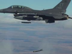 Collaborative small diameter bombs are launched from the wing of an F-16 fighter. Four of the bombs were dropped during the second flight demonstration of the Air Force Golden Horde Vanguard in March.  U.S. Air Force