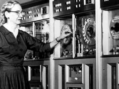 After serving in the U.S. Navy during World War II, Grace Hopper remained in the naval reserve. In 1952, her team at Remington Rand created the first compiler for computer languages, which was a precursor for COBOL. In this 1960 report, Hopper stands next to a mainframe computer that ran using COBOL. Courtesy of the Computer History Museum