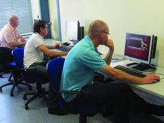 Students peer at computer screens as part of a COE DAT course in cyberspace attacks. As cyberspace becomes a more useful tool for terrorists, the COE DAT is increasing its work to identify how terrorists use it and to inform alliance partners on these new aspects.