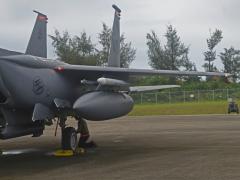 An airman from deployed from Mountain Home Air Force Base, Idaho, examines an F-15E Strike Eagle during preflight inspections at Tinian International Airport, Tinian during Pacific Iron 21 in August. To conduct such agile, more lethal movement of forces and airpower in the region, more software solutions are needed. Credit: U.S. Air Force photo by Tech. Sgt. Benjamin Sutton