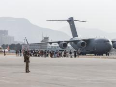 Evacuees load on to a United Arab Emirates (UAE) Boeing C-17 Globemaster III during the evacuation at Hamid Karzai International Airport, Kabul, Afghanistan, August 2021. The office of the Joint Staff J-6 initiated Project Orsus to overcome data challenges associated with the evacuation and say that project will likely impact the future of joint all-domain command and control.  U.S. Marine Corps photo by Sgt. Samuel Ruiz