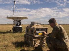 Airman 1st Class William King, USAF, technician, 352nd Special Operations Support Squadron, troubleshoots a modem connected to a parabolic dish in August, at RAF Mildenhall, England. JADC2 relies on globe-spanning high bandwidth links like these. U.S. Air Force photo by Airman 1st Class Joseph Barron