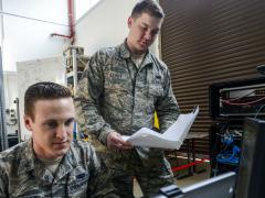 Senior Airman Thomas Goodnoe, USAF, tactical network operations technician, 1st Combat Communications Squadron (l), and Staff Sgt. Darryl Terry, USAF, cyber transport supervisor, 1st CBCS, review their systems against their technical guides during a cybersecurity audit in 2017 at Ramstein Air Base, Germany. The Air Force has added a new detachment that will provide initial training to cybersecurity airmen before they reach their mission locations. Credit: U.S. Air Force photo/Staff Sgt. Timothy Moore
