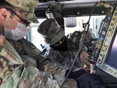 Army Sgt. Evan Tosunian (l) and Sgt. Allan Sosa, both assigned to the California Army National Guard’s 224th Sustainment Brigade, install single-channel ground and airborne radio systems in a Humvee at the National Guard armory in Long Beach, California, in May. The Army’s standardized, reprogrammable encryption chip known as RESCUE will help secure communications for radios, computers, unmanned vehicles and other systems. Credit: Army Staff Sgt. Matthew Ramelb, California Army National Guard