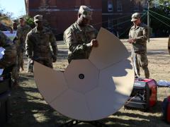 A soldier from Company B, 50th Expeditionary Signal Battalion-Enhanced, tears down a Very Small Aperture Terminal (VSAT) satellite dish during a demonstration on November 29, 2018, at Fort Bragg, North Carolina. Army leaders are working to bring advanced communications technologies into an integrated network. U.S. Army photo by Amy Walker, PM Tactical Network PEO C3T public affairs