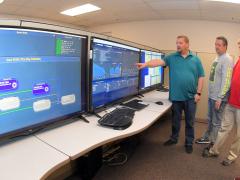 Engineers from the 517th Software Engineering Squadron, including (l-r) Carl Stuck and Scott Vigil, project directors; David Jolley, director; and Brent VanDerMeide, flight director, have created a new software development platform. U.S. Air Force photo by Todd Cromer